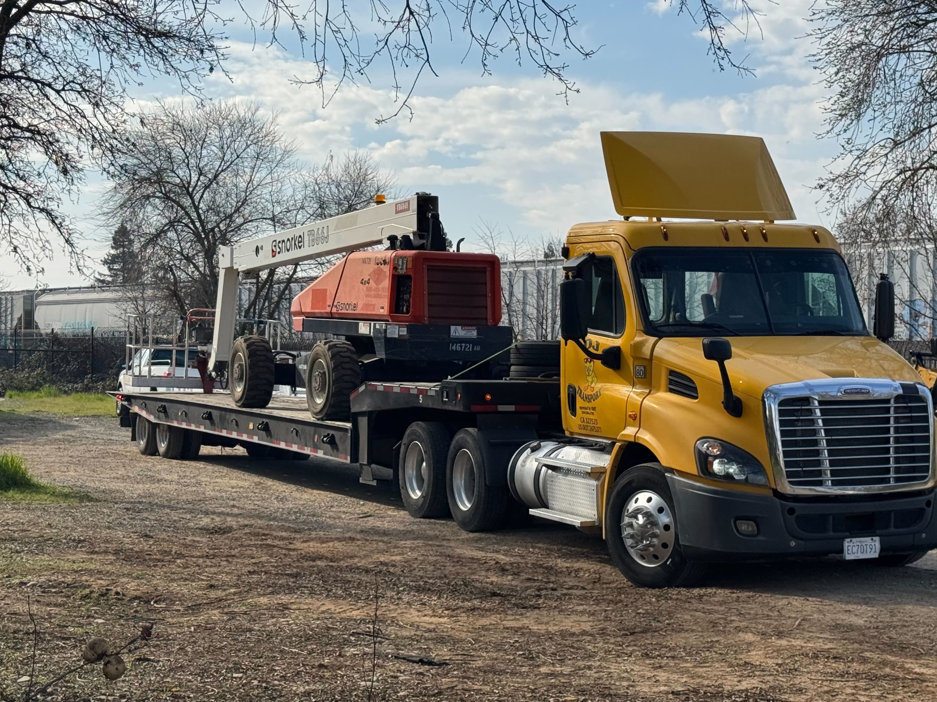 Heavy equipment being transported on a flatbed trailer